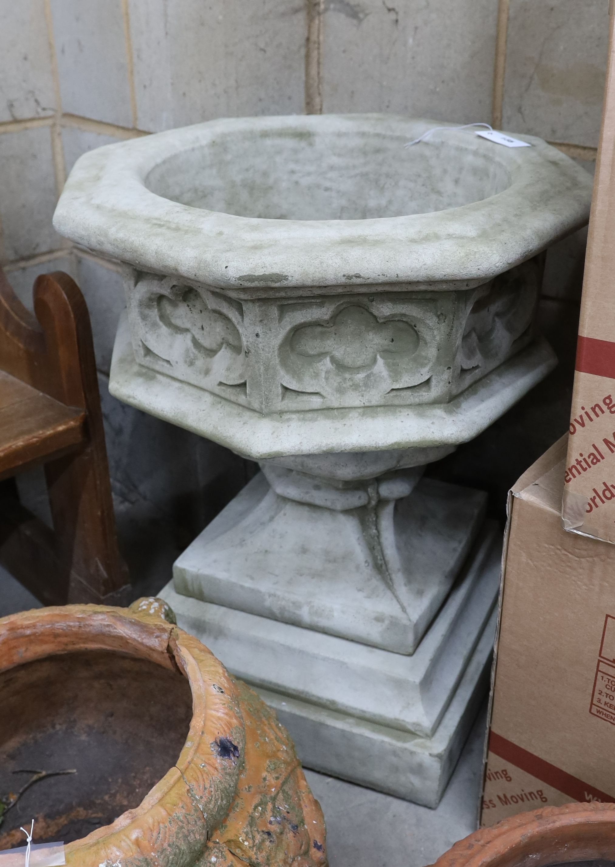 A reconstituted stone octagonal garden 'font' planter, width 60cm, height 74cm